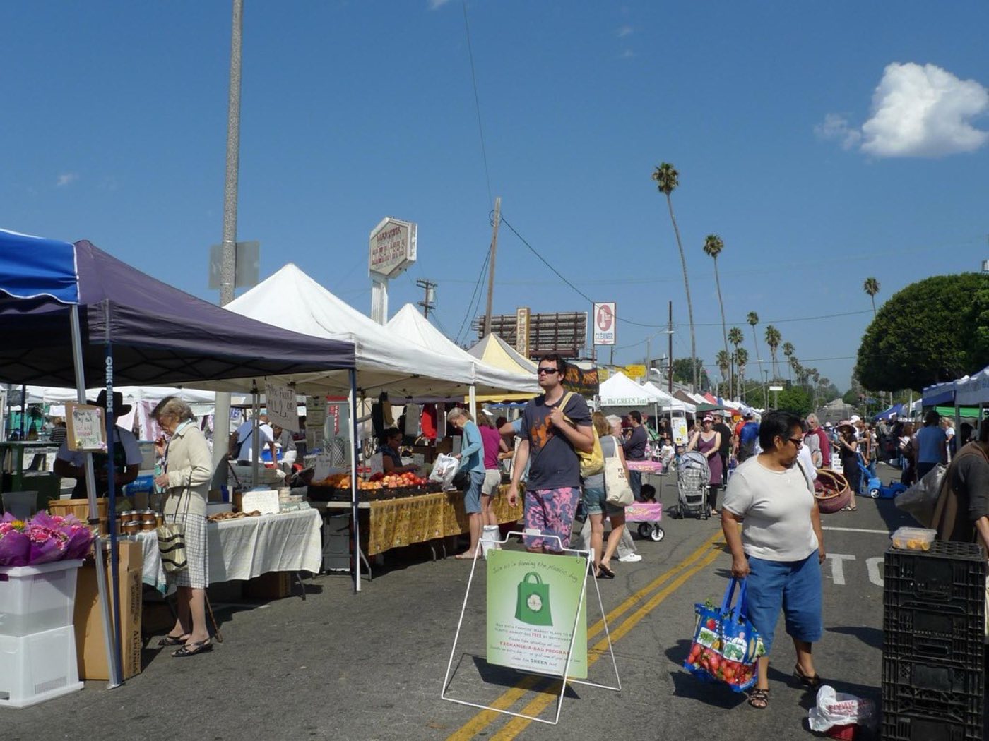 Shoppers and vendor tents at the Mar Vista Farmers Market in Los Angeles